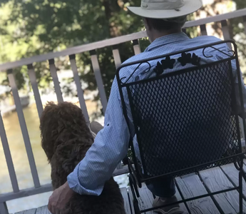 Man sitting with dog on porch